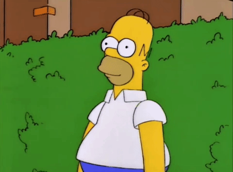 An animated gif of Homer Simpson fading into a bush