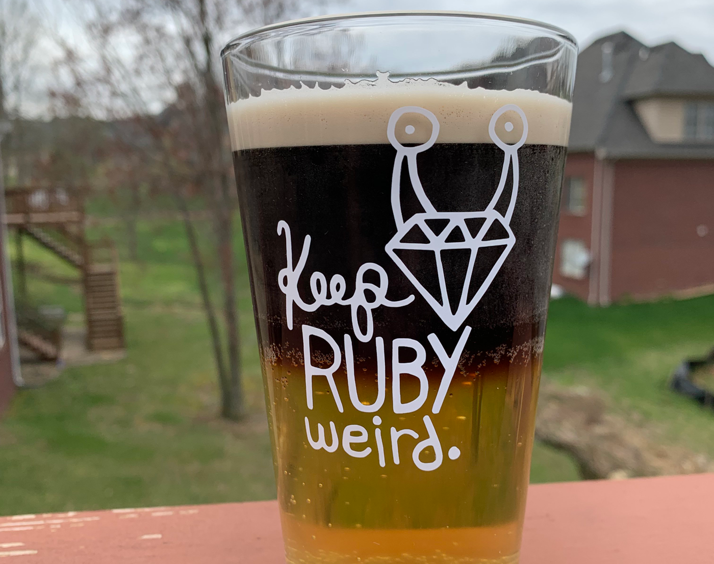 Keep Ruby Weird logo on a glass full of beer