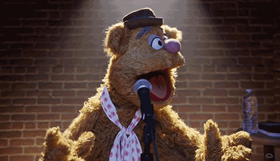 An animated gif of Fozzy Bear looking for laughs