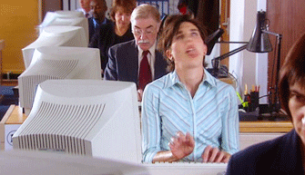 An animated gif of someone typing wildly at a computer in an office